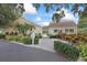 Community entrance with lush landscaping and a welcoming pathway, ensuring privacy for members and guests at 2850 Doone Cir, Palm Harbor, FL 34684