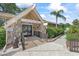 Charming entrance to Lake Tarpon Lodge, showcasing stone accents and welcoming landscaping at 2850 Doone Cir, Palm Harbor, FL 34684