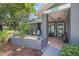 Inviting front porch with tiled floor, charming decor, and a welcoming atmosphere at 2850 Doone Cir, Palm Harbor, FL 34684