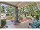 Charming front porch featuring tiled floors, garden views and outdoor seating at 2850 Doone Cir, Palm Harbor, FL 34684