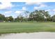 Lush green golf course with a sand trap in the foreground, inviting players to enjoy a round of golf at 2850 Doone Cir, Palm Harbor, FL 34684