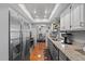 Well-equipped kitchen with stainless steel refrigerator and views into the dining area at 2850 Doone Cir, Palm Harbor, FL 34684