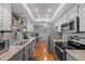 Long kitchen featuring granite countertops, stainless steel appliances, and ample cabinet space at 2850 Doone Cir, Palm Harbor, FL 34684