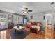 Comfortable living room with wood-style floors, bright windows, and a cozy sectional sofa at 2850 Doone Cir, Palm Harbor, FL 34684