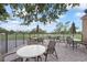 Relax on this outdoor patio with multiple seating options overlooking the green lawn and distant trees at 2850 Doone Cir, Palm Harbor, FL 34684