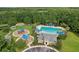 Aerial view of the community pool, playground, and clubhouse surrounded by lush green landscaping at 2903 Cordoba Ranch Blvd, Lutz, FL 33559