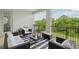Inviting outdoor balcony with stylish furniture, striped rug, and views of surrounding trees at 2903 Cordoba Ranch Blvd, Lutz, FL 33559