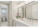 Bathroom featuring double sinks, quartz countertop, large mirrors, and bright lighting at 2903 Cordoba Ranch Blvd, Lutz, FL 33559
