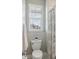 Bathroom with a toilet, window, towel rack and shower and a black and white pattern curtain at 2903 Cordoba Ranch Blvd, Lutz, FL 33559
