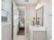 Bright bathroom featuring white tile floors and vanity, with an open doorway to the bedroom at 2903 Cordoba Ranch Blvd, Lutz, FL 33559