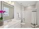 Bright bathroom featuring white cabinets, quartz countertops, and a shower/bathtub combo at 2903 Cordoba Ranch Blvd, Lutz, FL 33559