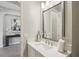 Bright bathroom featuring a modern vanity with white countertop and stylish fixtures and a decorative mirror at 2903 Cordoba Ranch Blvd, Lutz, FL 33559