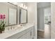 Bathroom featuring double sinks, quartz countertop, large mirrors, and bright lighting at 2903 Cordoba Ranch Blvd, Lutz, FL 33559