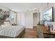 Bright bedroom featuring hardwood floors, a decorative wall art, and a TV for comfortable living at 2903 Cordoba Ranch Blvd, Lutz, FL 33559