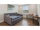 Cozy bedroom with stylish daybed, wooden floors, and a bright window, perfect for relaxation at 2903 Cordoba Ranch Blvd, Lutz, FL 33559