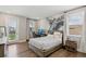 Bedroom with a platform bed, hardwood floors, light gray paint, a large window, and a desk for study at 2903 Cordoba Ranch Blvd, Lutz, FL 33559