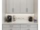 Close up of a light and bright coffee bar area with a variety of appliances and decor at 2903 Cordoba Ranch Blvd, Lutz, FL 33559