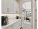 Bright coffee bar featuring subway tile backsplash, quartz countertop, and views to the living room at 2903 Cordoba Ranch Blvd, Lutz, FL 33559