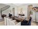 Elegant dining room featuring wood-look floors, neutral decor, and staircase at 2903 Cordoba Ranch Blvd, Lutz, FL 33559