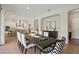 Dining room adjacent to an open kitchen and featuring stylish chairs and lighting fixtures at 2903 Cordoba Ranch Blvd, Lutz, FL 33559