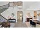 Elegant foyer featuring staircase, wood floors, iron banister, and open access to dining area at 2903 Cordoba Ranch Blvd, Lutz, FL 33559