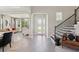 Elegant foyer with wood-look flooring, staircase, and open view to the living room at 2903 Cordoba Ranch Blvd, Lutz, FL 33559
