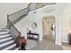 Grand foyer with staircase, wood floors, high ceilings, iron banister, and stylish decor accents at 2903 Cordoba Ranch Blvd, Lutz, FL 33559