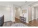 Upper hallway boasts wood flooring, arched doorways, and a decorative table with mirror accent at 2903 Cordoba Ranch Blvd, Lutz, FL 33559