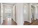 Upstairs hallway featuring hardwood floors, neutral paint, white trim, and archways leading to the bedrooms and bathrooms at 2903 Cordoba Ranch Blvd, Lutz, FL 33559