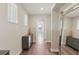 Bright hallway featuring hardwood floors, neutral paint, white trim, and a decorative wood vase on a dark gray accent table at 2903 Cordoba Ranch Blvd, Lutz, FL 33559