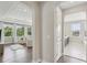 Hallway view into the main bedroom featuring hardwood floors, white trim, and an archway leading to the main bathroom at 2903 Cordoba Ranch Blvd, Lutz, FL 33559