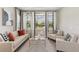 Bright living room featuring neutral furniture, a modern rug, and large windows with natural light at 2903 Cordoba Ranch Blvd, Lutz, FL 33559