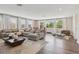 Expansive living room with hardwood floors, a comfortable sectional, and ample natural light at 2903 Cordoba Ranch Blvd, Lutz, FL 33559