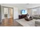 Living room view with hardwood floors, entertainment center, and a peek at the bathroom at 2903 Cordoba Ranch Blvd, Lutz, FL 33559