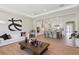 Bright living room open to modern kitchen with large island and stainless steel appliances at 2903 Cordoba Ranch Blvd, Lutz, FL 33559