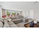 Spacious living room featuring hardwood floors, a comfortable sectional, and large windows at 2903 Cordoba Ranch Blvd, Lutz, FL 33559