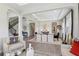 Open-concept living space with wood-look floors connecting the living room, dining area, and staircase at 2903 Cordoba Ranch Blvd, Lutz, FL 33559