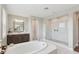 Spacious main bathroom features a soaking tub, double vanity, and a glass-enclosed shower with a built-in seat at 2903 Cordoba Ranch Blvd, Lutz, FL 33559