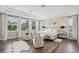 Spacious main bedroom with tray ceiling, hardwood floors, sitting area, and large windows with natural light at 2903 Cordoba Ranch Blvd, Lutz, FL 33559