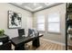 Home office with a sleek black desk, modern computer setup, and natural light from windows at 2903 Cordoba Ranch Blvd, Lutz, FL 33559