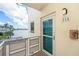 Balcony view with water and palm trees outside unit 215 at 2960 59Th S St # 215, Gulfport, FL 33707