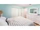 View of light and airy bedroom with hardwood floors and white dresser at 2960 59Th S St # 215, Gulfport, FL 33707