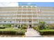 Front exterior of the building with flag and landscaping at 2960 59Th S St # 215, Gulfport, FL 33707