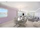 Open-concept living and dining area featuring a waterfront view, tile floors, and a stylish dining table with modern chairs at 2960 59Th S St # 215, Gulfport, FL 33707