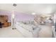 Spacious living room featuring tile floors, a comfortable sectional, and an open layout leading to the dining area at 2960 59Th S St # 215, Gulfport, FL 33707