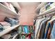 Organized walk-in closet featuring shelving for clothes, purses, and storage, with pink walls at 2960 59Th S St # 215, Gulfport, FL 33707