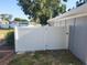 Green backyard with a white vinyl fence for privacy offering a secure space for outdoor activities and relaxation at 310 4Th Ave. Southwest, Ruskin, FL 33570