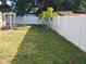 Green backyard with a white vinyl fence, some trees, and an outdoor bench with swing set for a nice relaxing outdoor living at 310 4Th Ave. Southwest, Ruskin, FL 33570