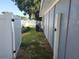Backyard area with a white fence for privacy and an AC unit; perfect for some outside space and relaxation at 310 4Th Ave. Southwest, Ruskin, FL 33570