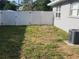 Fenced backyard area featuring lush grass, offering privacy and space for outdoor activities and relaxation at 310 4Th Ave. Southwest, Ruskin, FL 33570